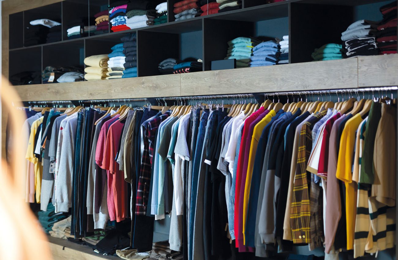 Assorted casual men clothes on shelves