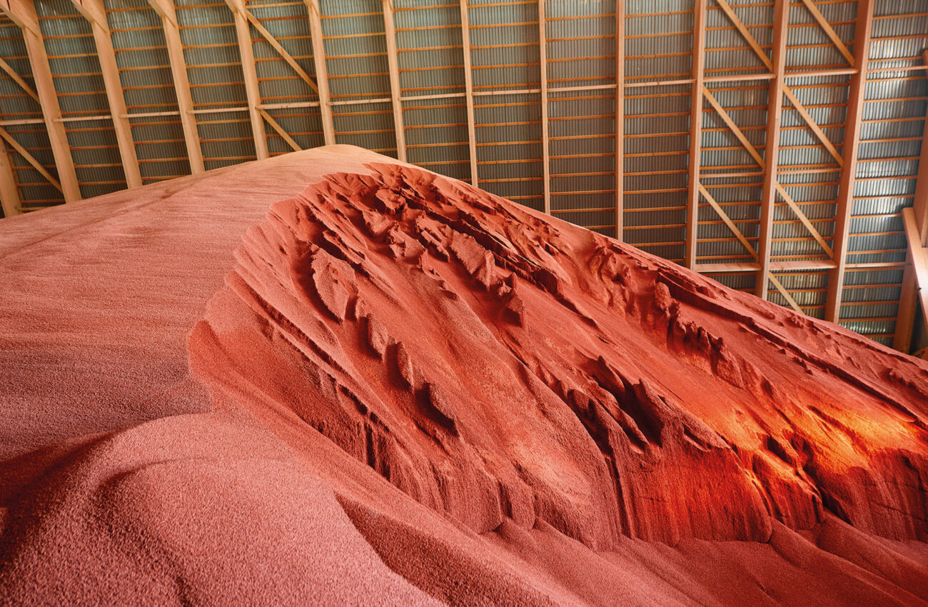 High pile of red color potassium fertilizers in storehouse